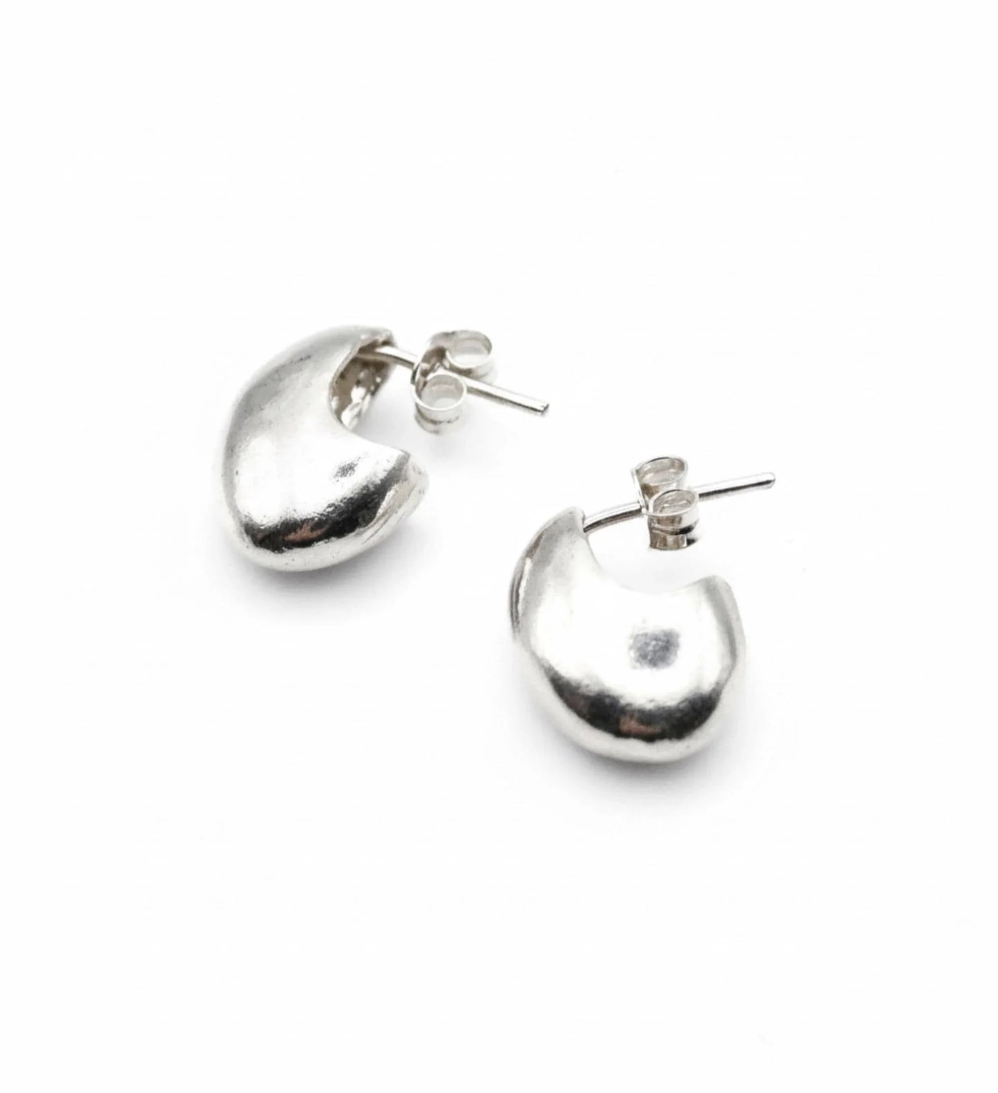 Chunky silver crescent stud earrings minimalist modern jewelry on white background