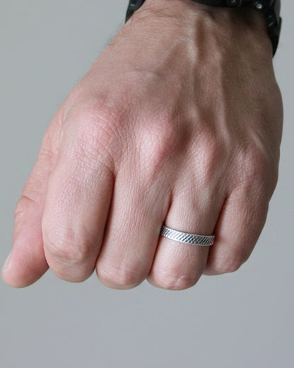 Hand with a ring on a blurred background