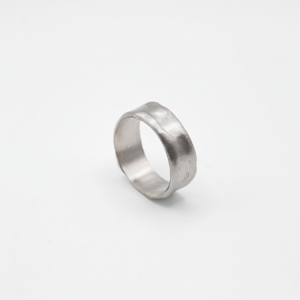 Silver ring on a light gray background
