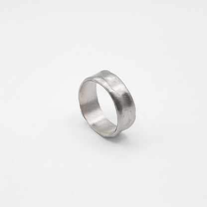 Silver ring on a light gray background
