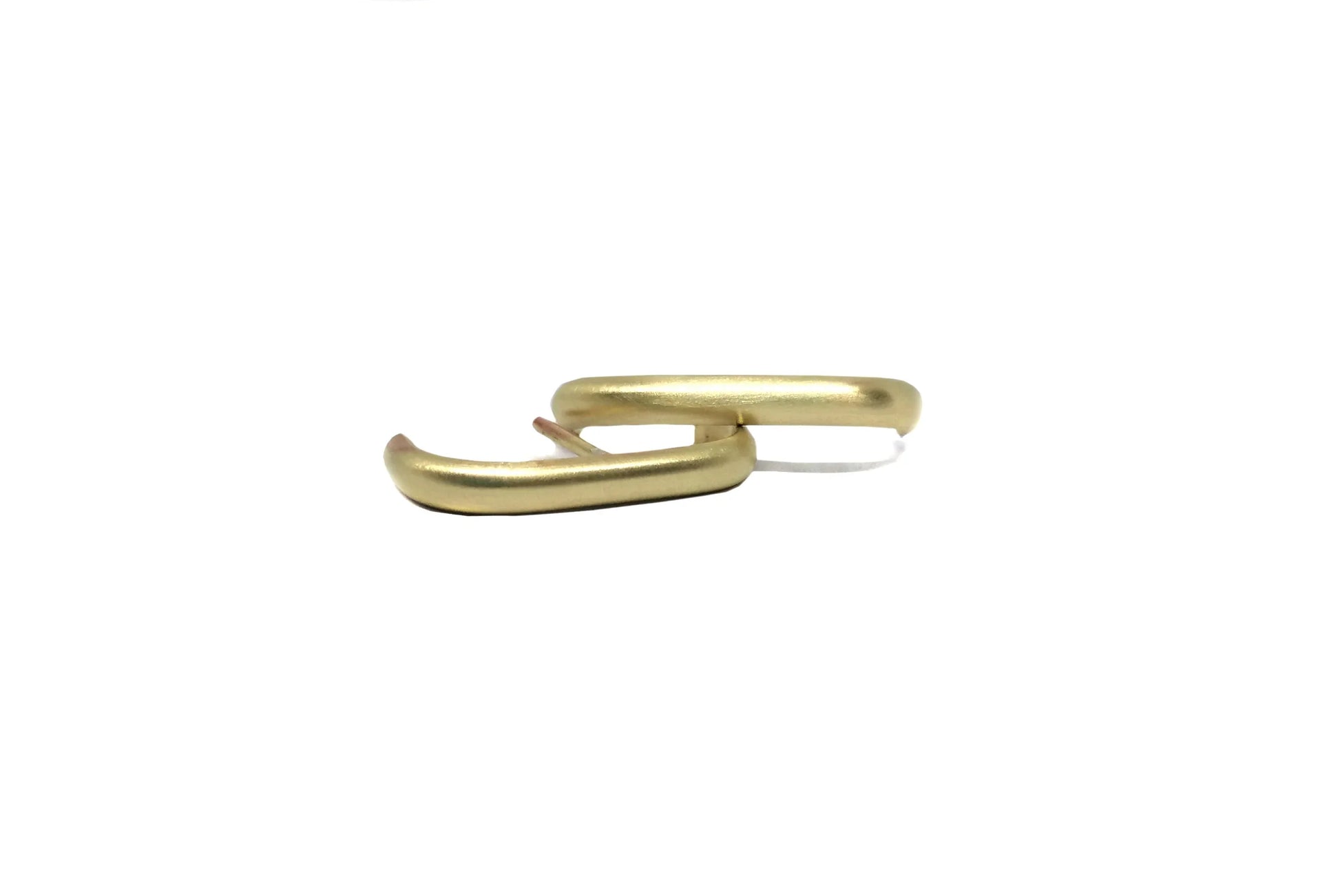 Minimalist gold hoop earrings, matte finish, modern jewelry on white background