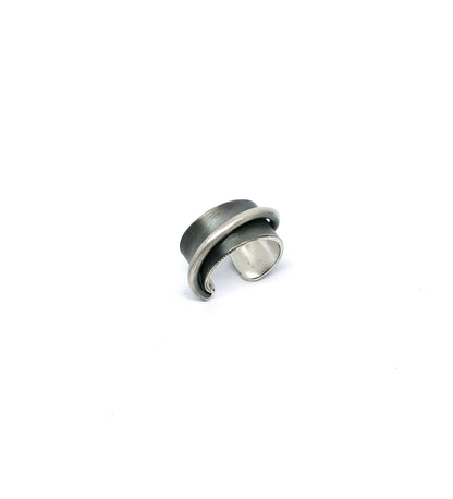 Silver ring with a black interior on a white background