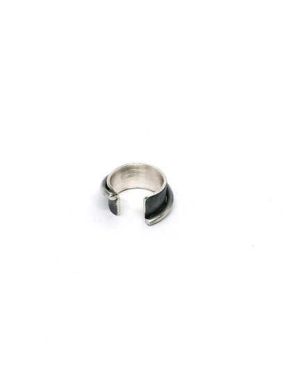 Silver ring with black accent on a white background
