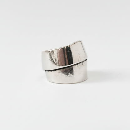 Silver ring with a green stone on a white background