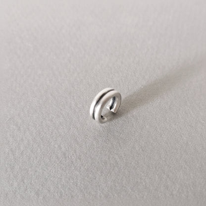 Silver ring on a light gray background