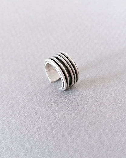 Silver ring with multiple bands on a light gray background
