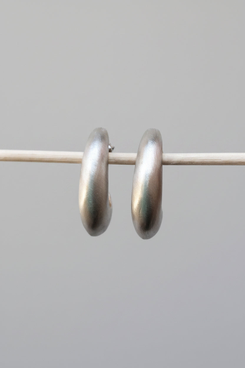 Pair of silver hoop earrings on a white background