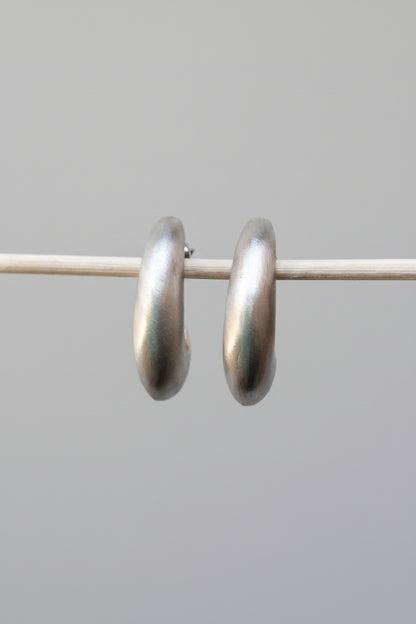 Pair of silver hoop earrings on a white background