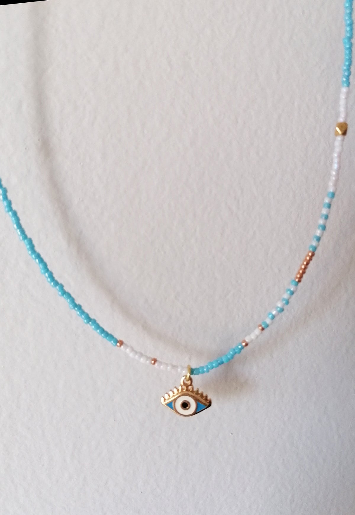 Necklace with an eye pendant on a white background