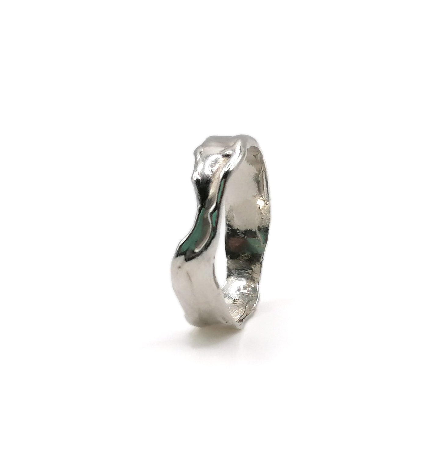 A polished silver ring with an organic, wavy, textured band, shown from a side profile on a clean white background.