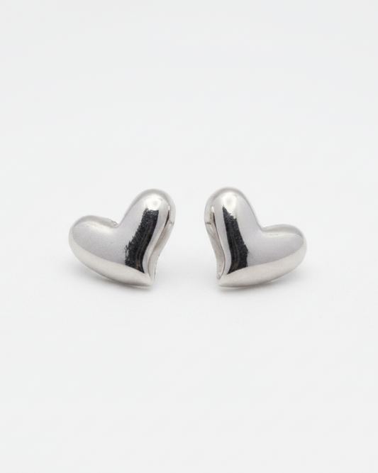 Heart-shaped silver earrings on a white background
