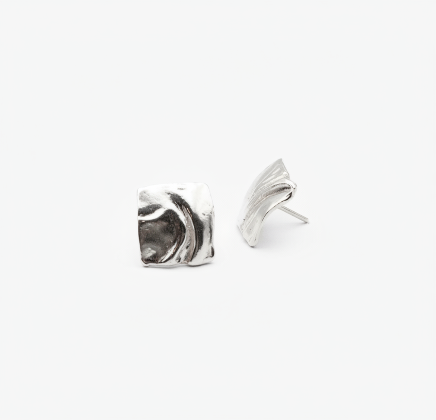 Pair of silver wing-shaped earrings on a white background