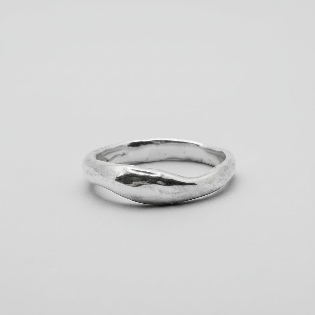 Silver ring on a light gray background
