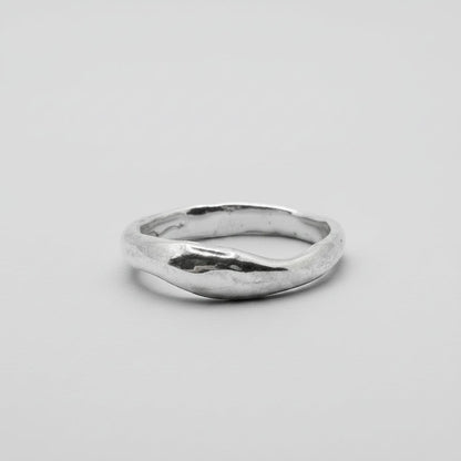 Silver ring on a light gray background