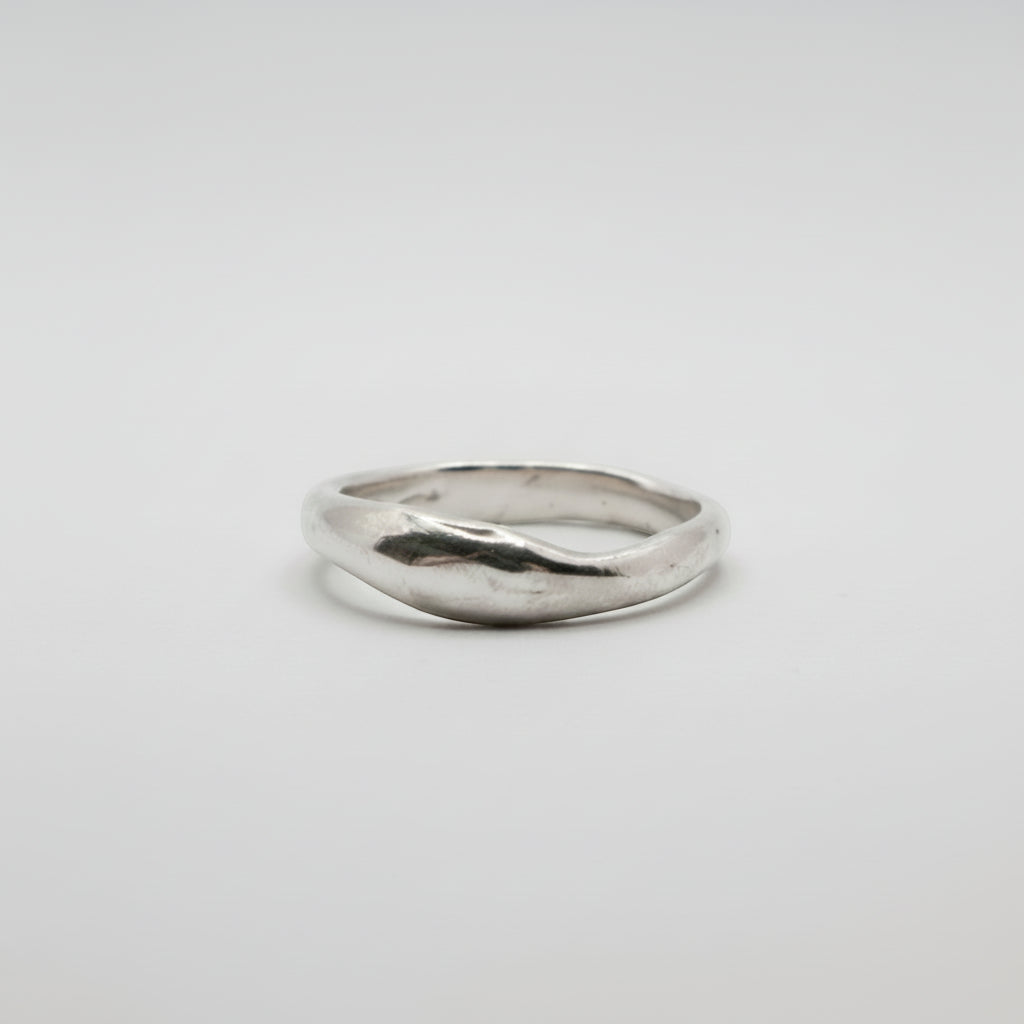 Silver ring on a light gray background