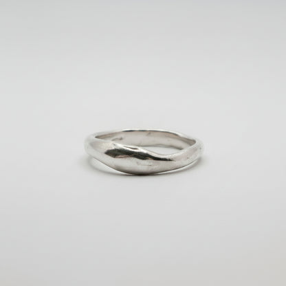 Silver ring on a light gray background