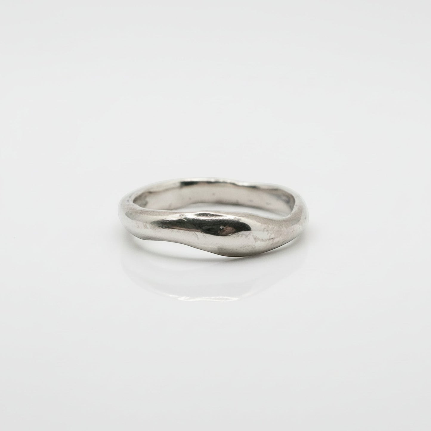 Silver ring on a light gray background