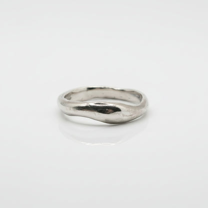 Silver ring on a light gray background