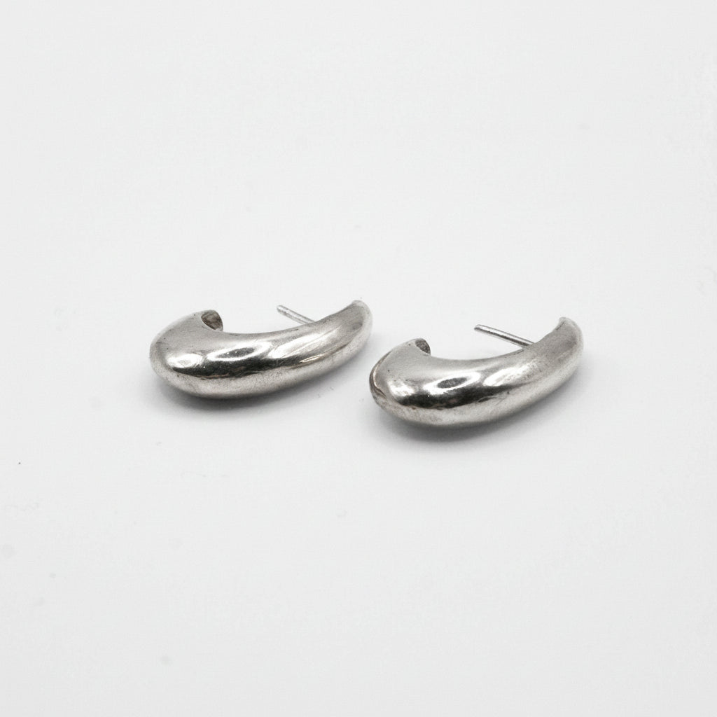Pair of silver hoop earrings on a white background