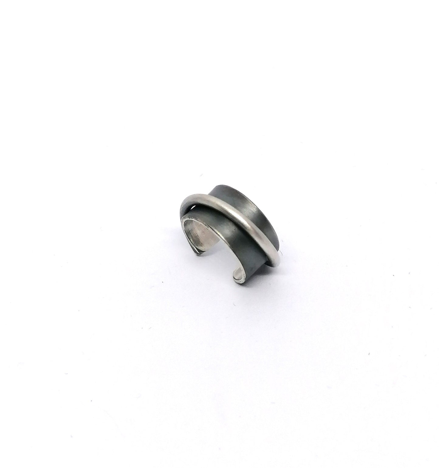 Silver and black ring on a white background