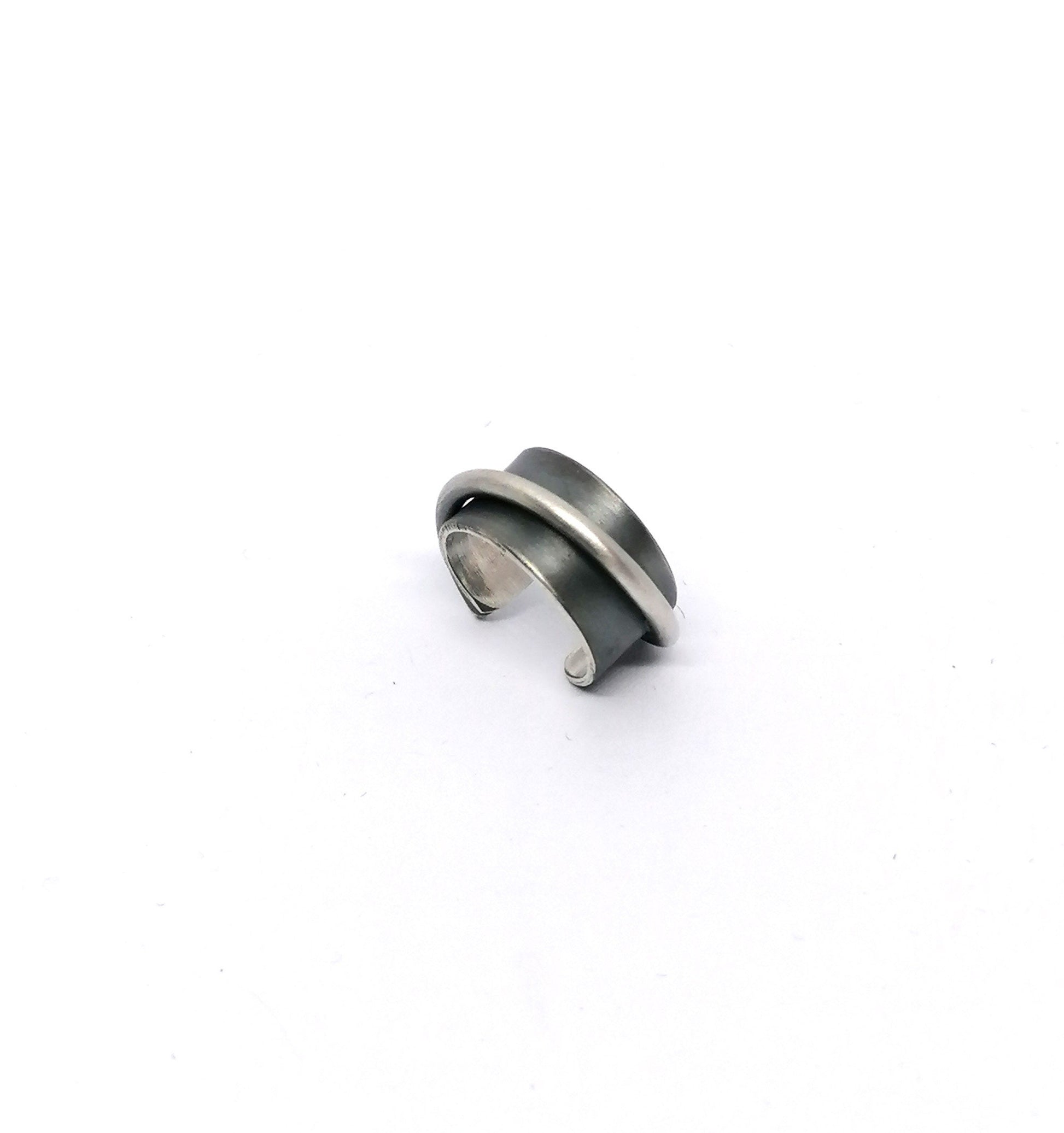 Silver and black ring on a white background