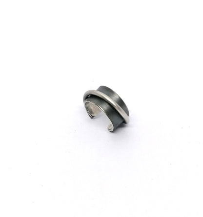 Silver and black ring on a white background
