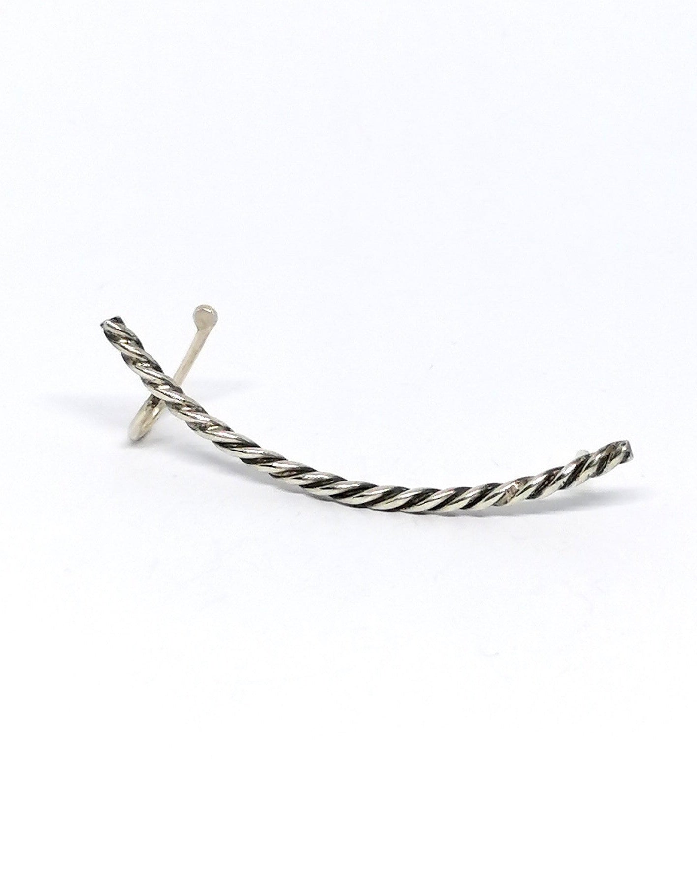 Silver earring on a white background