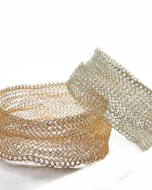 Two gold mesh bracelets on a white background