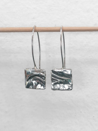 Handmade silver square dangle earrings with textured abstract design on simple hooks