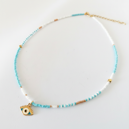 Evil eye beaded necklace with turquoise, white and gold glass seed beads and gold enamel evil eye charm, product shot on white background