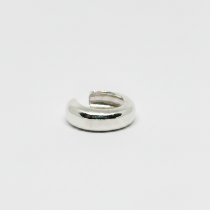 Silver ring on a light gray background