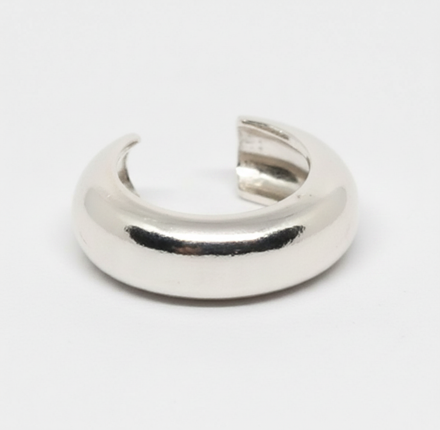 Silver crescent moon-shaped object on a white background