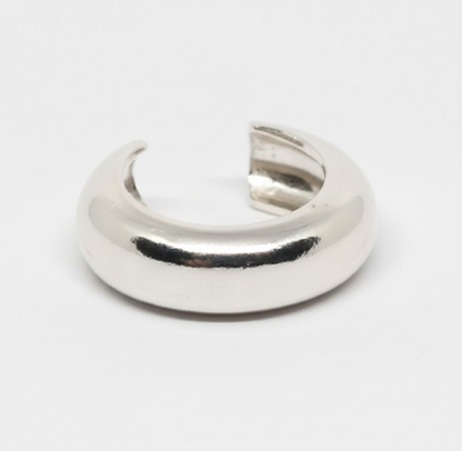 Silver crescent moon-shaped object on a white background