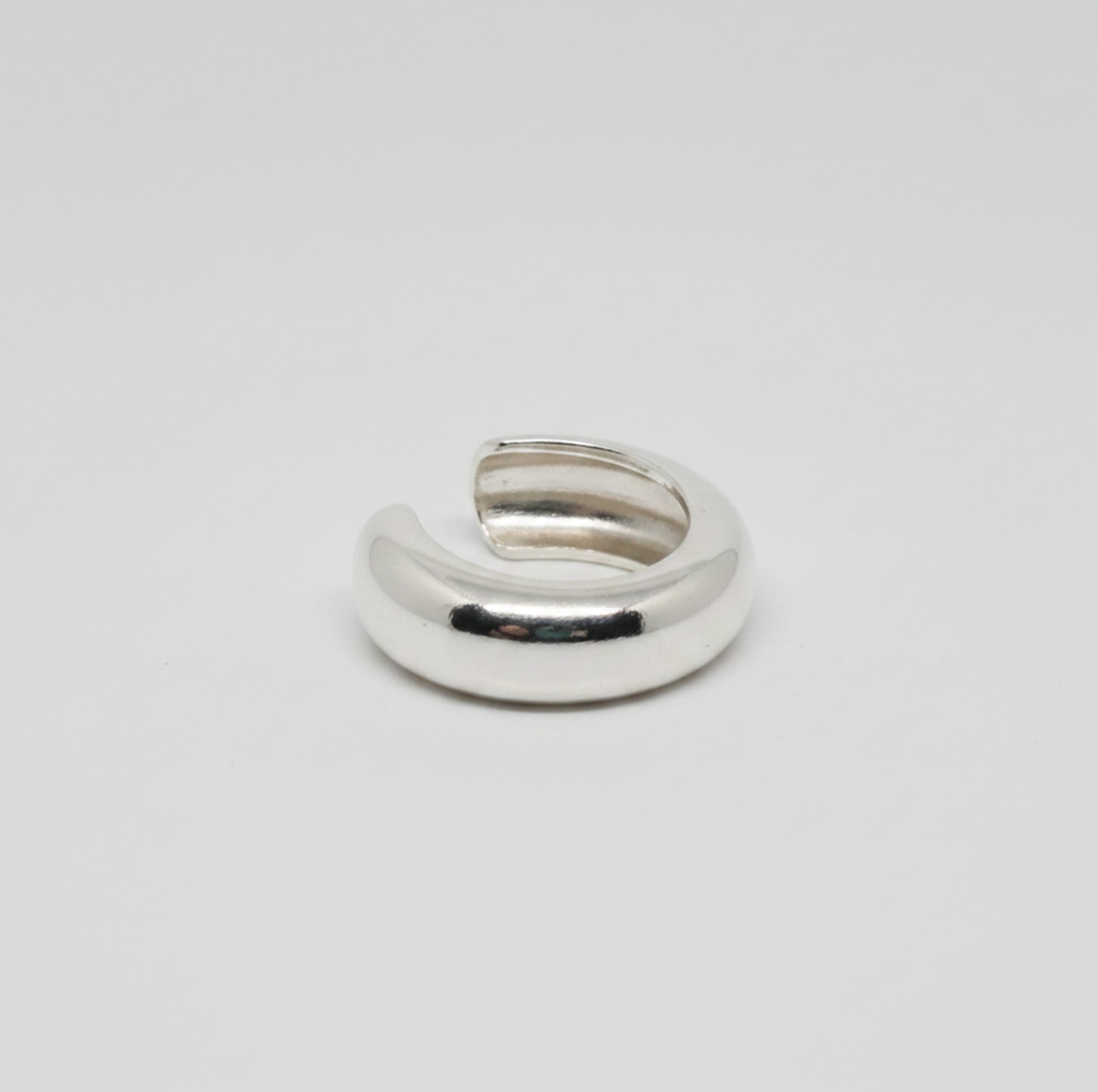 Silver ring on a light gray background