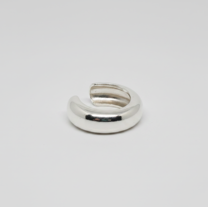 Silver ring on a light gray background