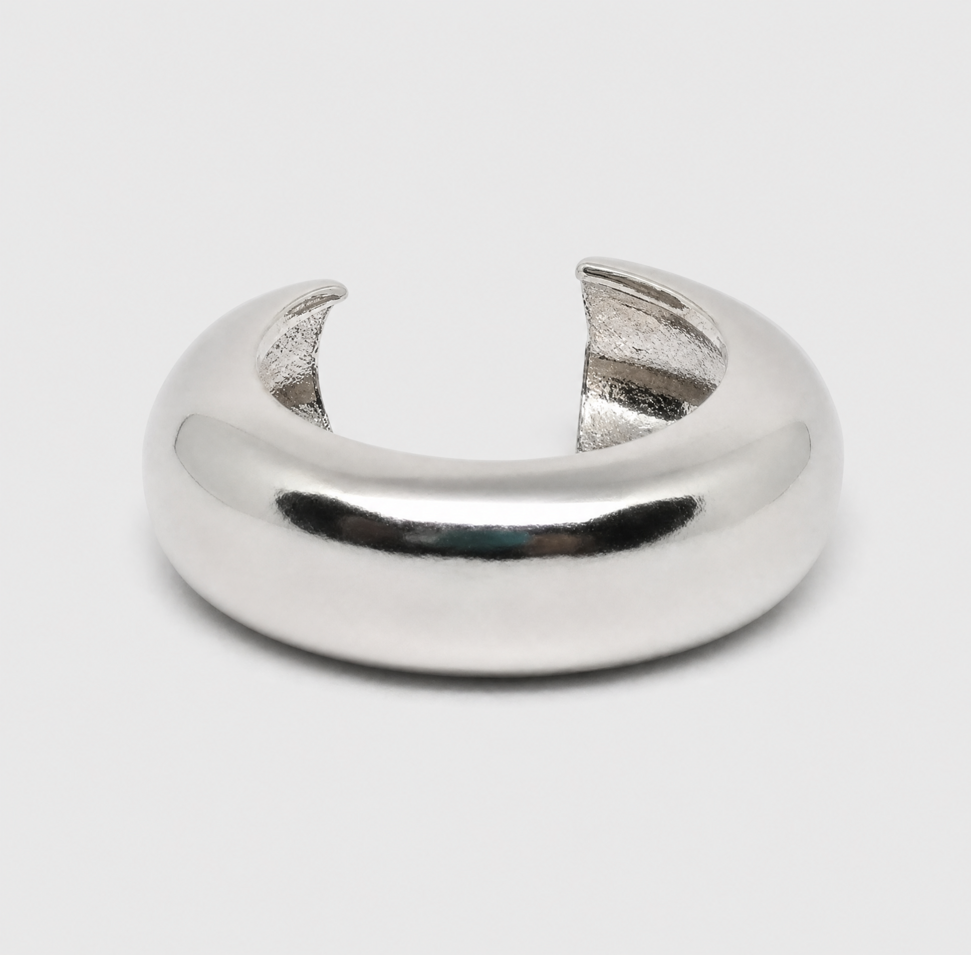 Silver ring with a unique design on a light gray background