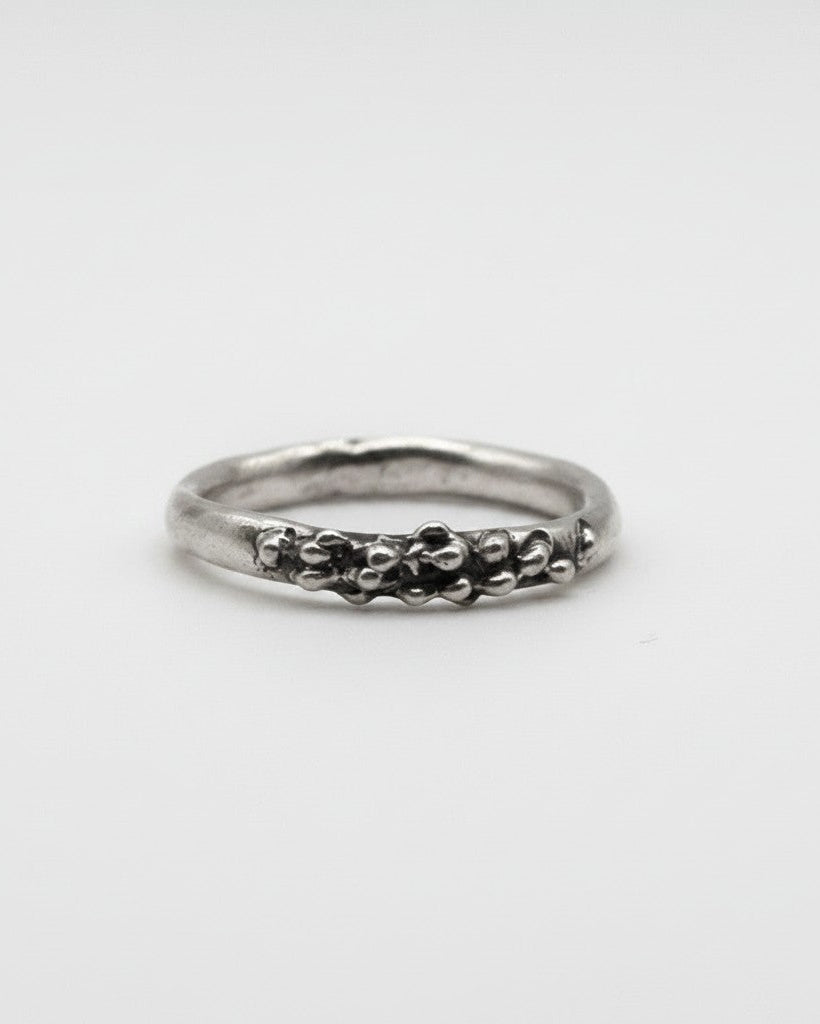 SosyGallery sterling silver ring with an irregular, sculptural textured band and organic bead-like details.