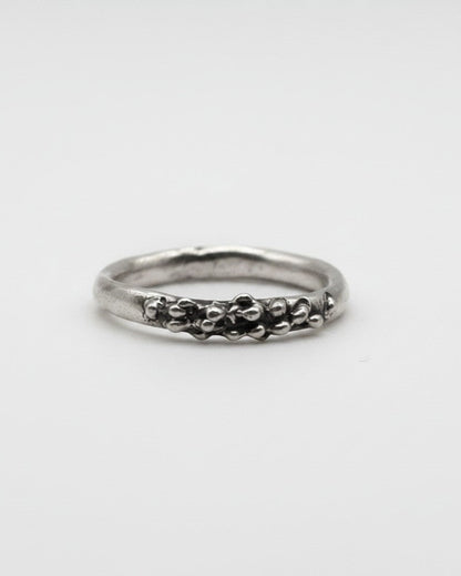 SosyGallery sterling silver ring with an irregular, sculptural textured band and organic bead-like details.