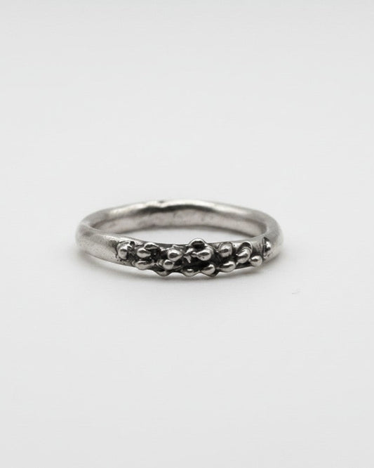 SosyGallery sterling silver ring with an irregular, sculptural textured band and organic bead-like details.