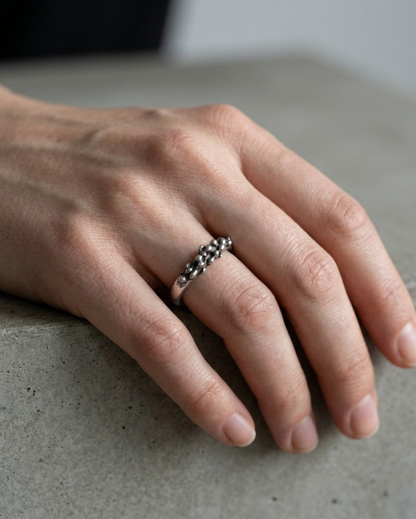 SosyGallery irregular 925 sterling silver band ring with a sculptural, textured design worn on a hand.