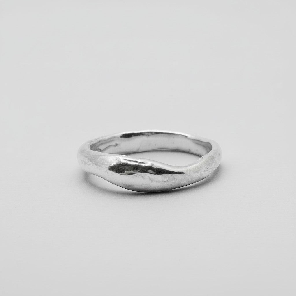 Silver ring on a light gray background