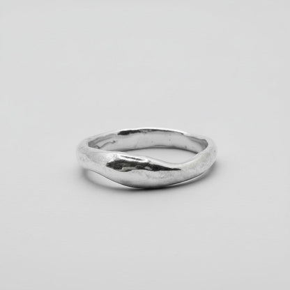 Silver ring on a light gray background