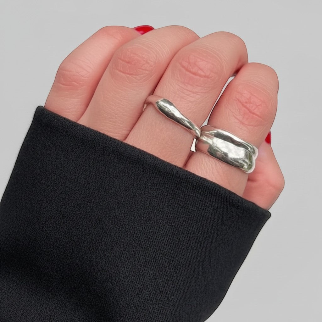 SosyGallery sterling silver rings with irregular organic shapes worn on fingers with red nail polish.