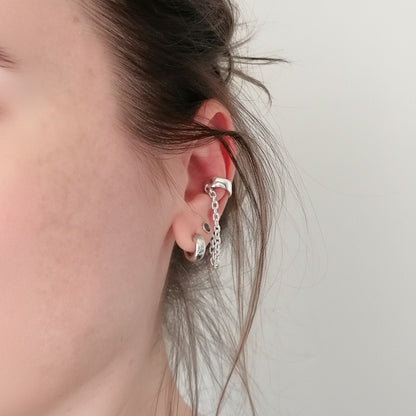 SosyGallery sterling silver conch ear cuff with delicate chain detail, worn on a model for a modern non-pierced look.