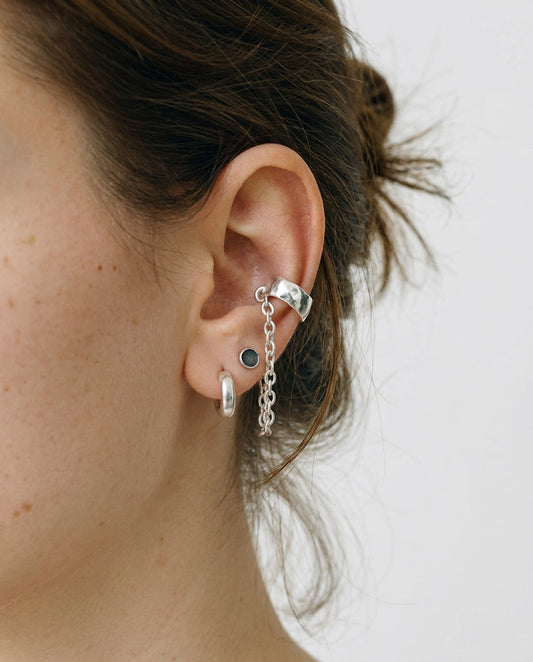 SosyGallery sterling silver conch ear cuff with delicate chain detail worn on a model's ear, no piercing required.