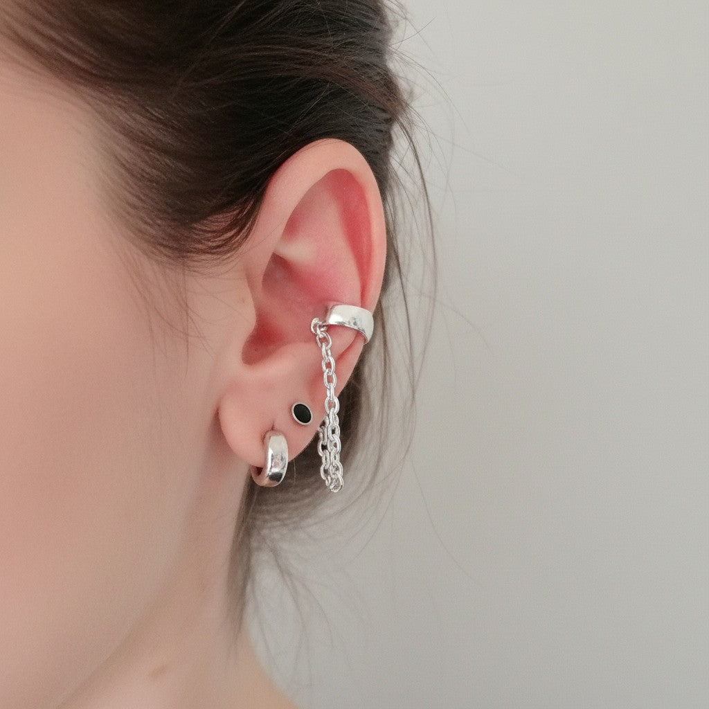 SosyGallery sterling silver conch ear cuff with delicate chain detail worn on a model, non-piercing design.