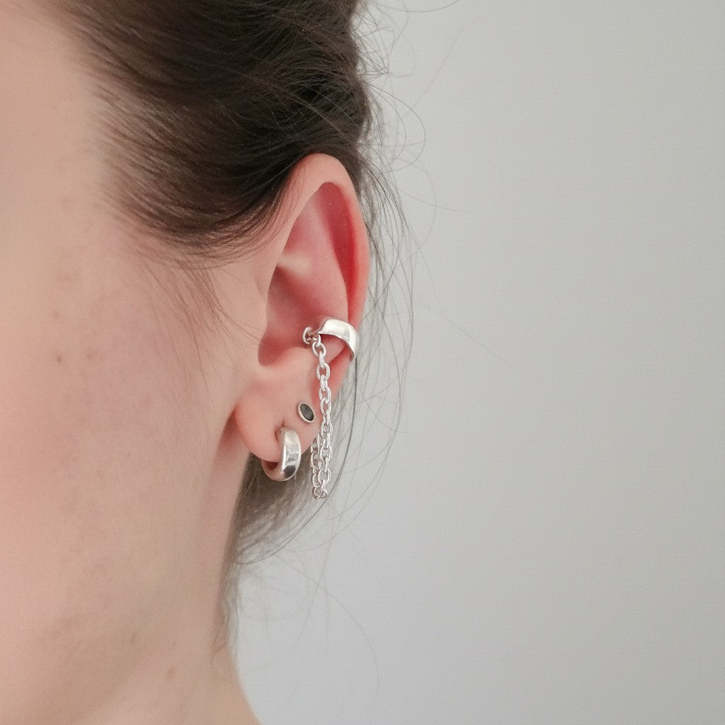 SosyGallery sterling silver conch ear cuff with delicate chain detail, worn on ear without piercing for edgy style.