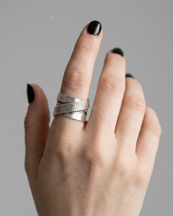 SosyGallery wide 925 sterling silver multi-band ring with brushed finish and textured crosshatch detail on finger.