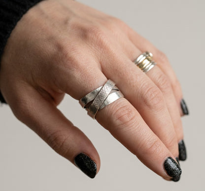 SosyGallery wide 925 sterling silver multi-band ring with textured crosshatch detail and a brushed finish on a hand.